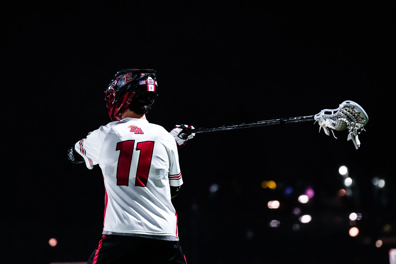 Silhouetted of a lacrosse player.
