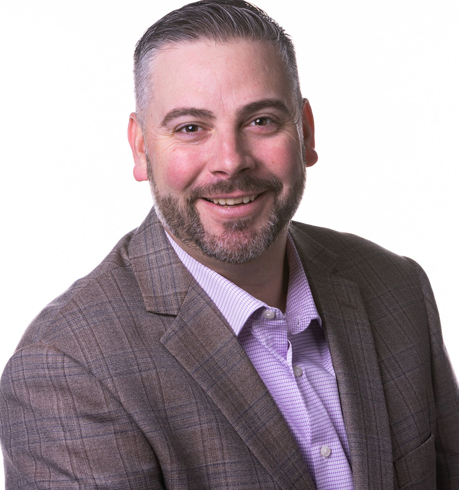 Professional headshot of a smiling businessman with a beard wearing a gray blazer and purple dress shirt.