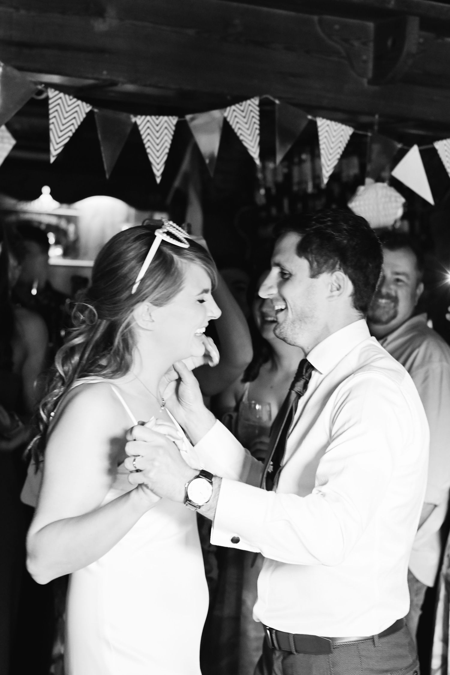 Black and white photo of a bride and groom sharing their first dance at a rustic wedding venue in eastbourne Sussex