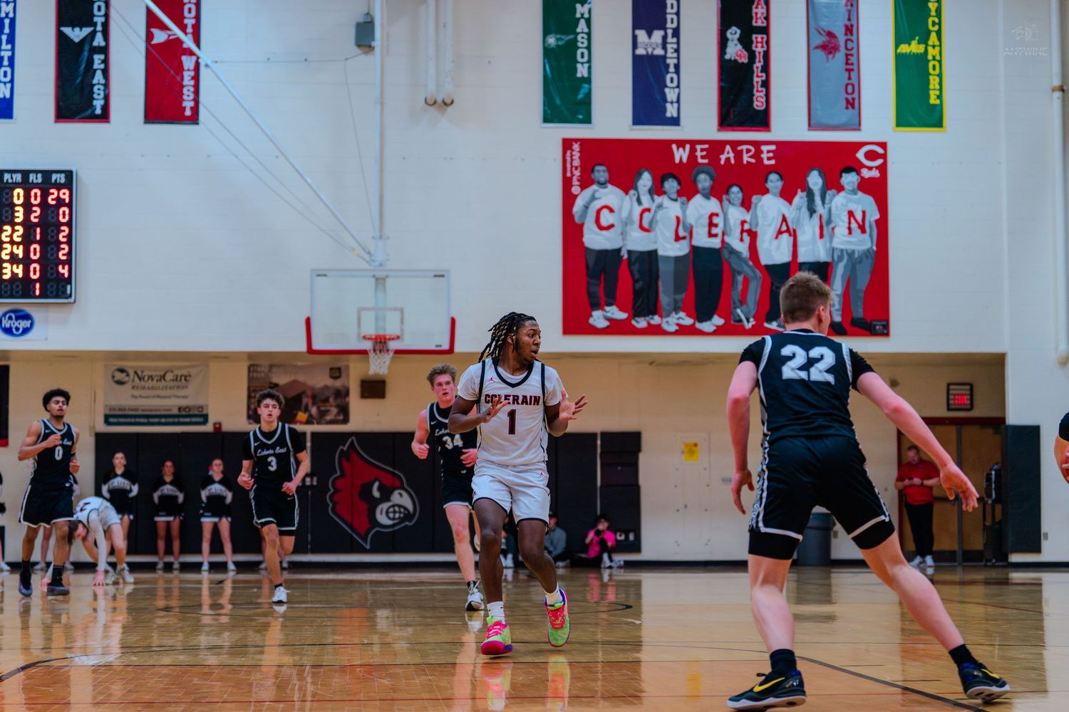 Colerain Cardinals basketball player #1 drives past defender during indoor high school game.