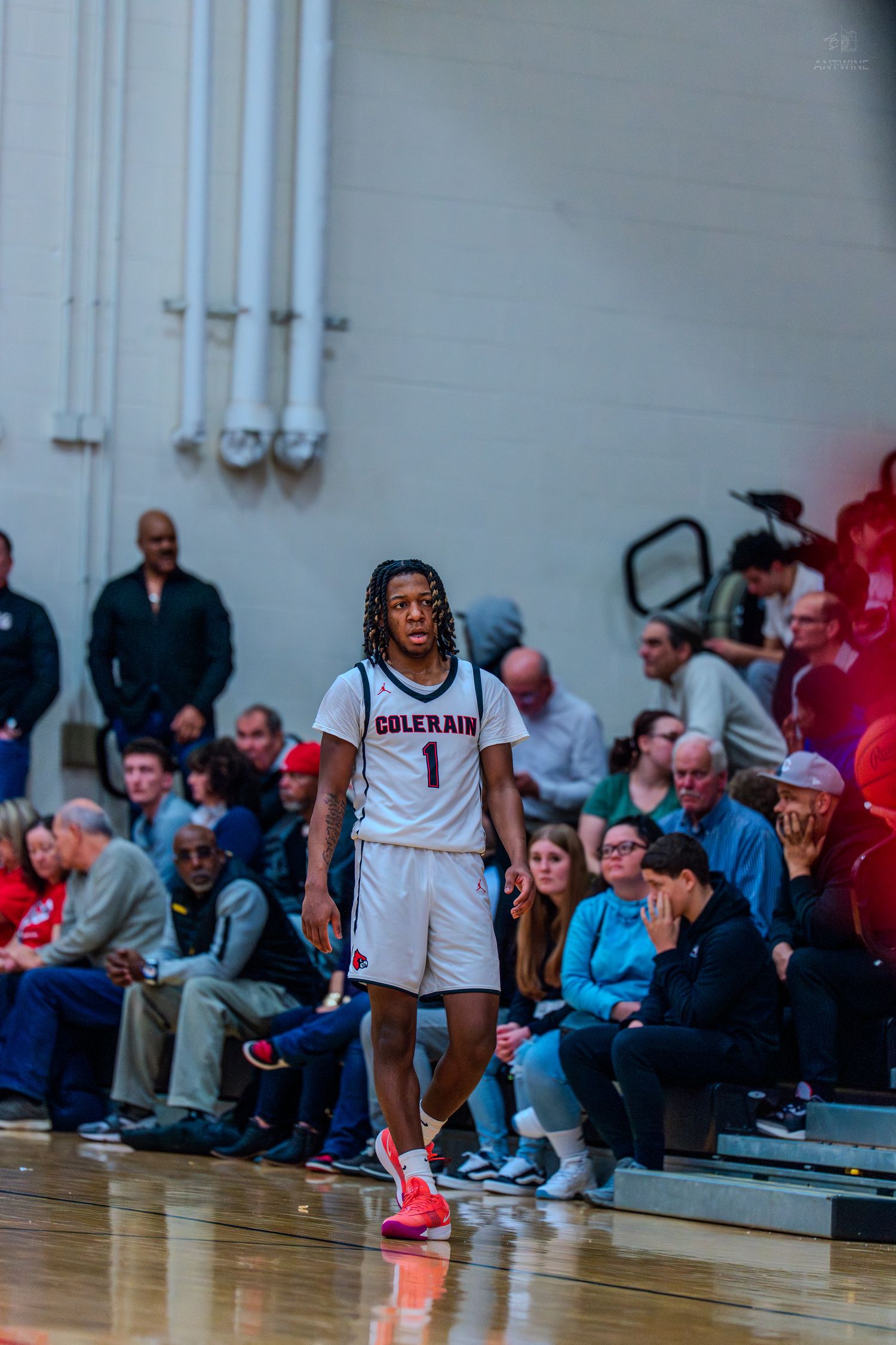 Colerain basketball player number 1 walks on the court during a crowded home game.
