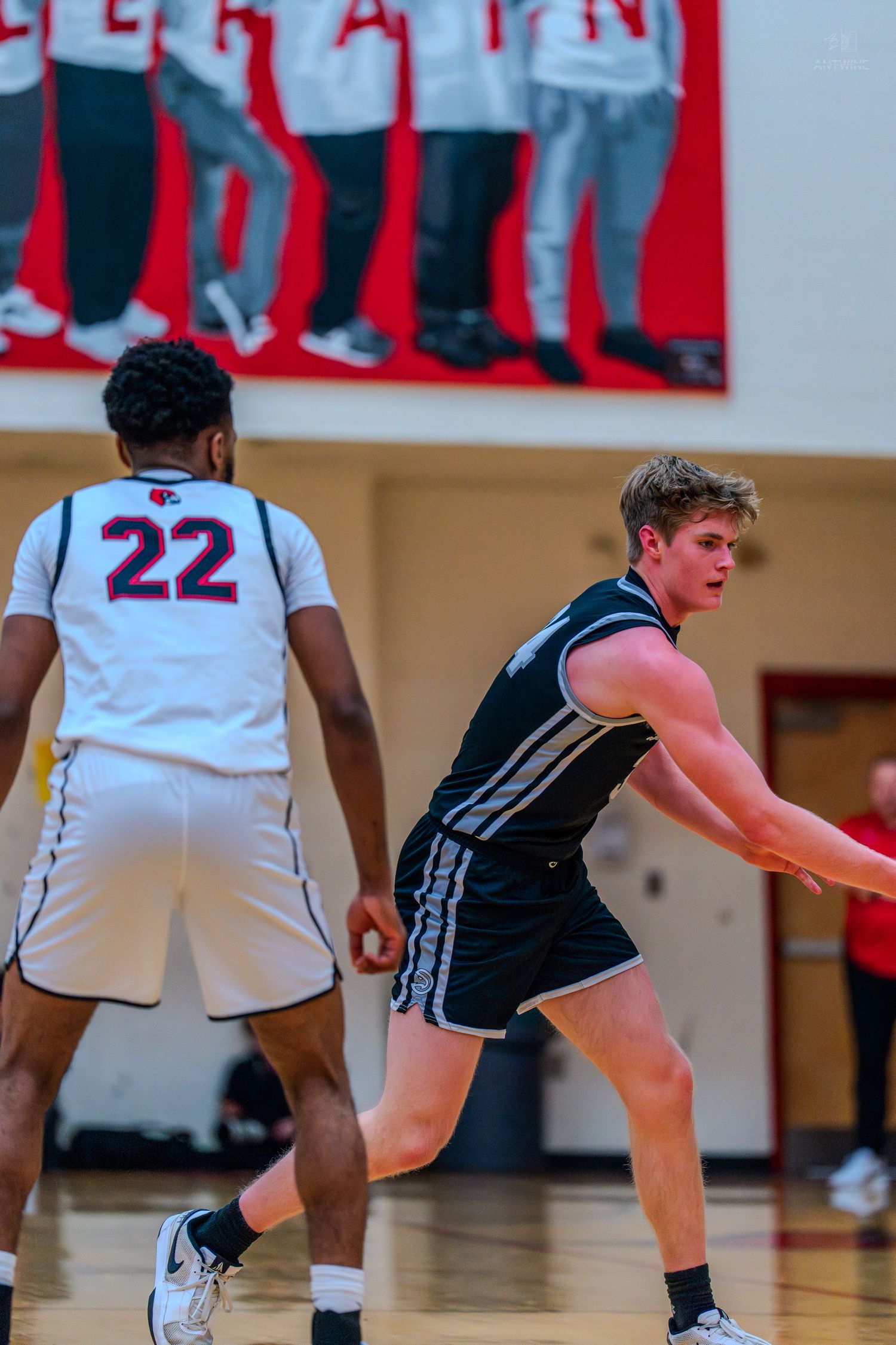 Lakota East basketball player defends against opponent #22 during a high school game.