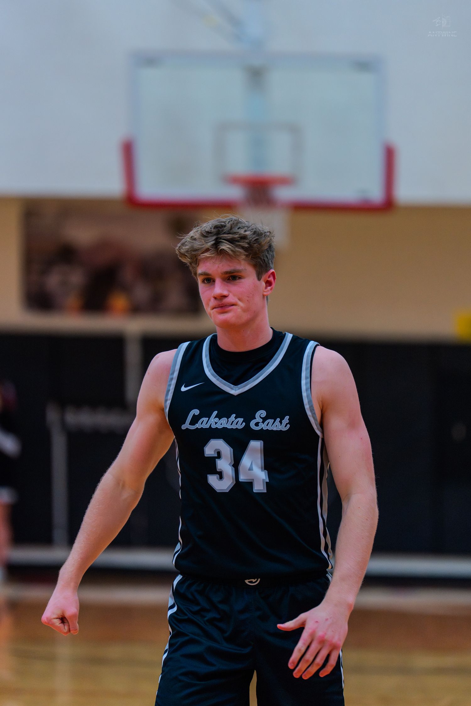 Lakota East high school basketball player number 34 stands on court.