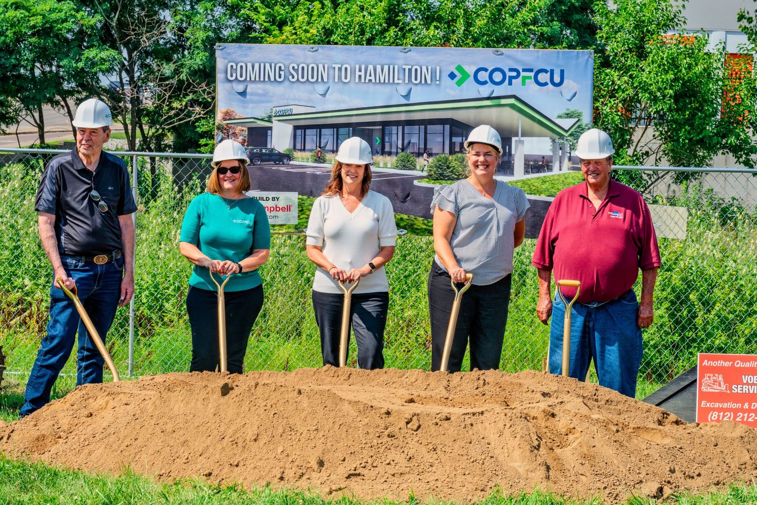 Group of five people with gold shovels at COPFCU Hamilton branch groundbreaking ceremony.