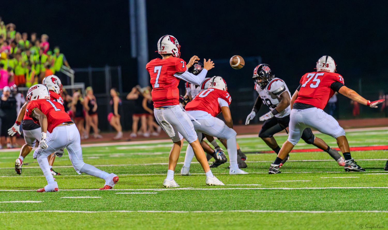 Colerain number 7 quarterback throws a pass while under pressure from the opposing defense.