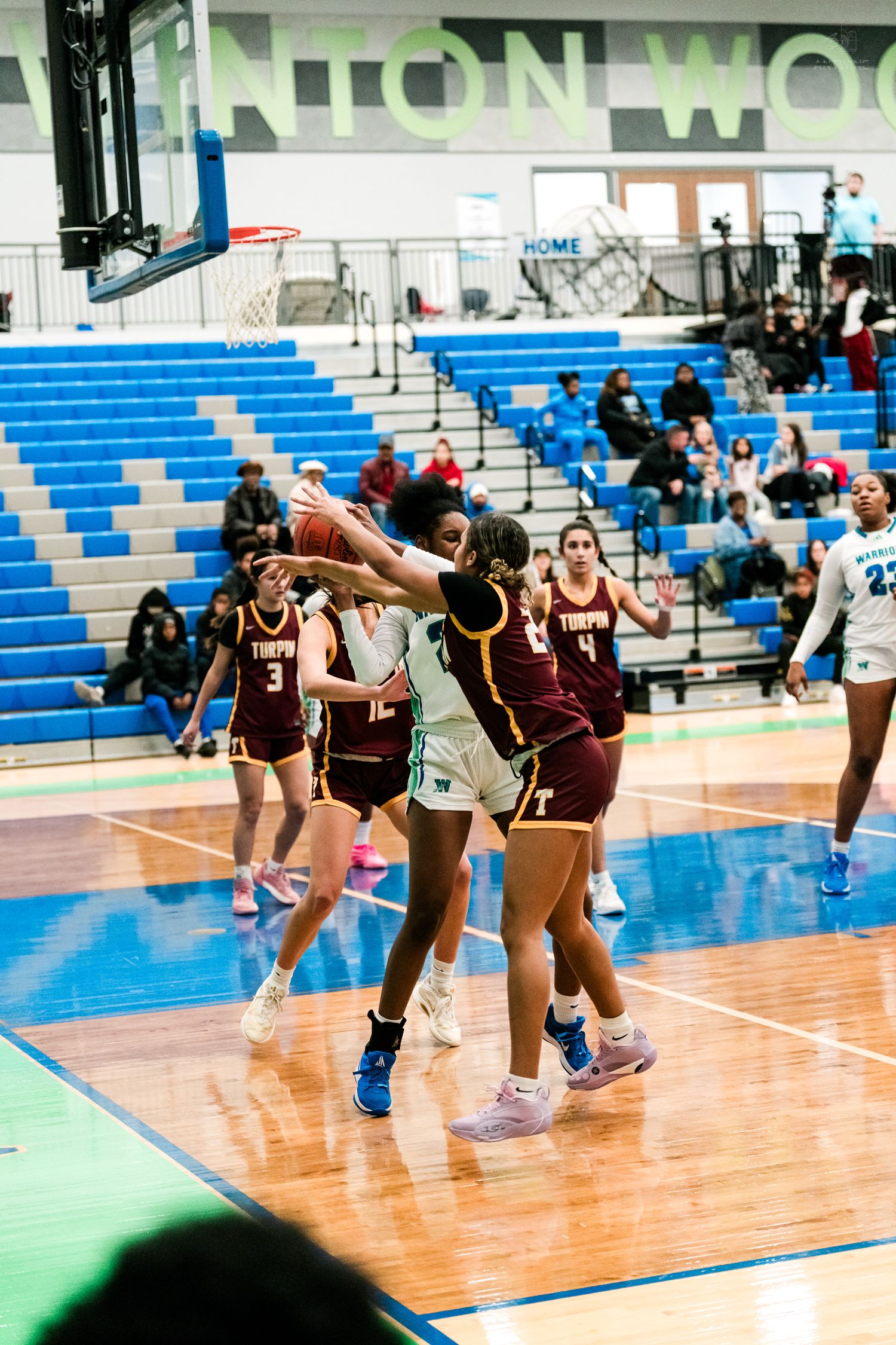 Girls basketball players battle for possession during an intense Winton Woods home game against Turpin.