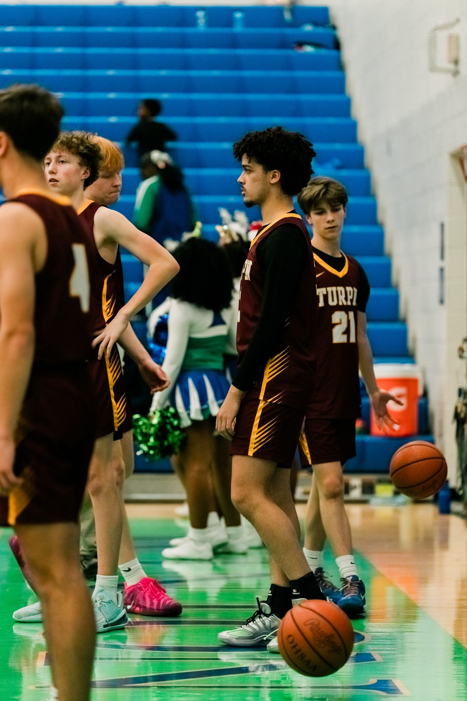 Turpin basketball team players warming up with dribbling drills before game.
