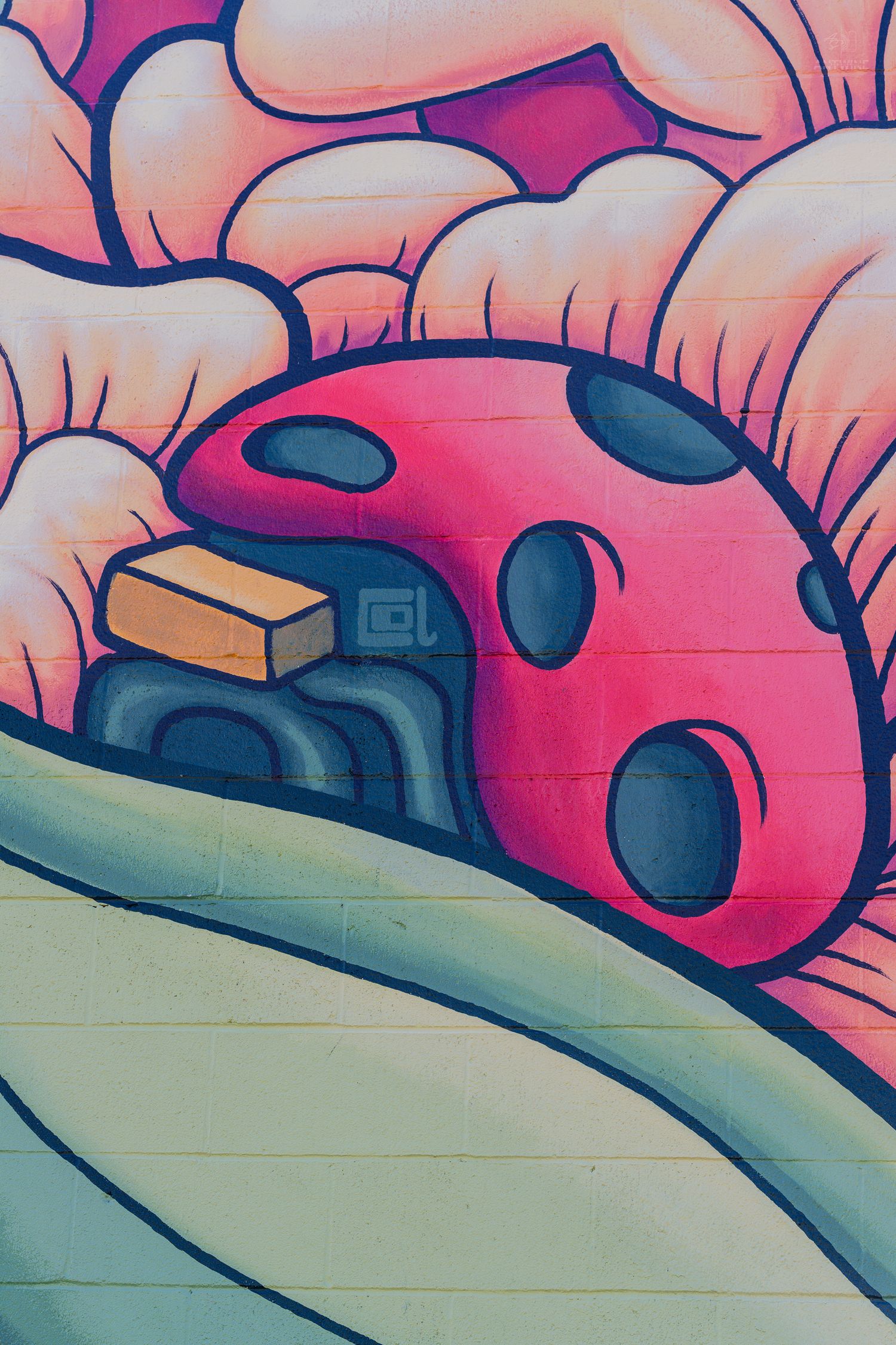 Colorful graffiti mural featuring a red ladybug with dark spots on rolling green hills with pink clouds.