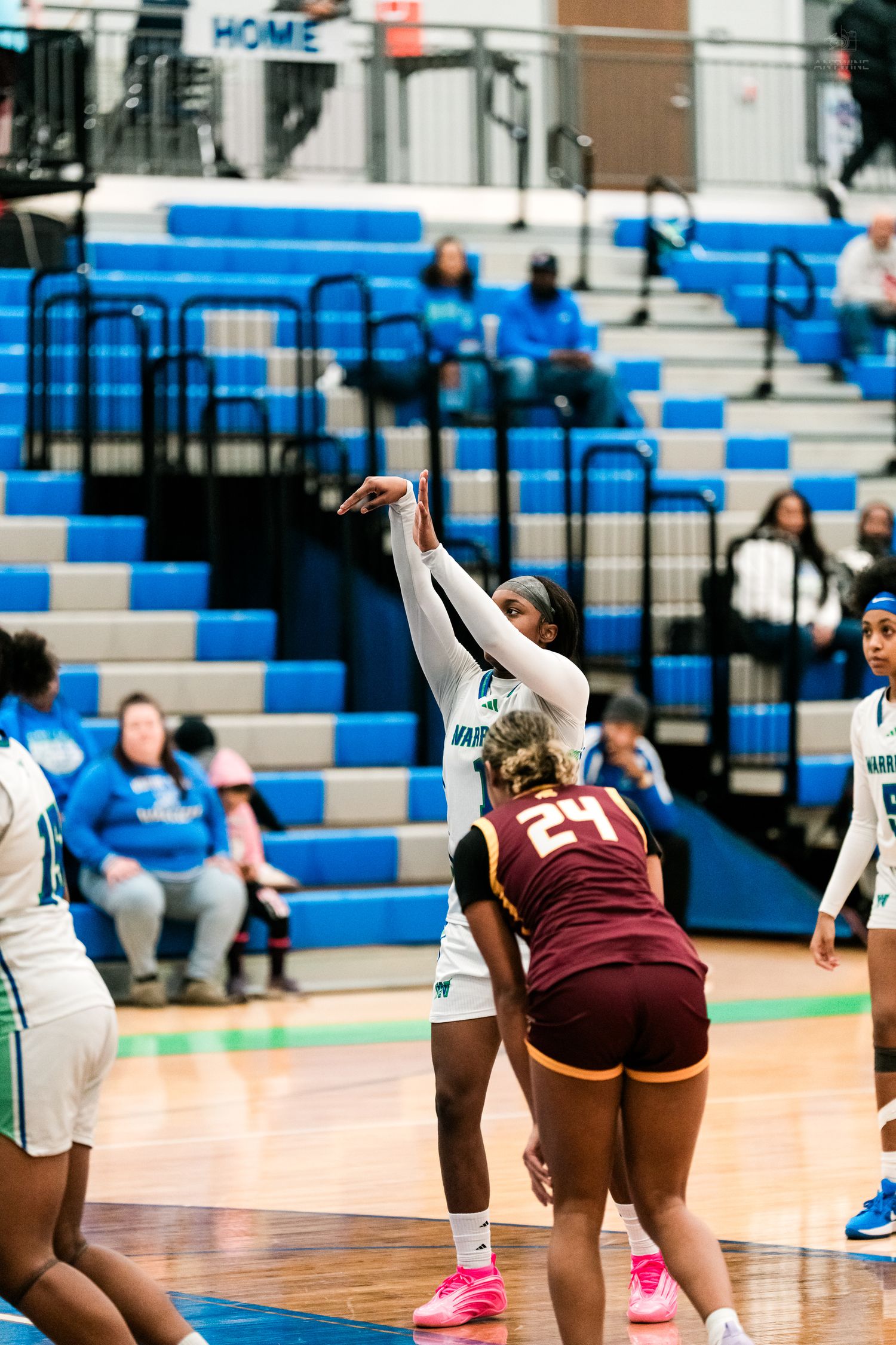 Warriors player shoots over Turpin #24 defender in a girls high school basketball game at home court.