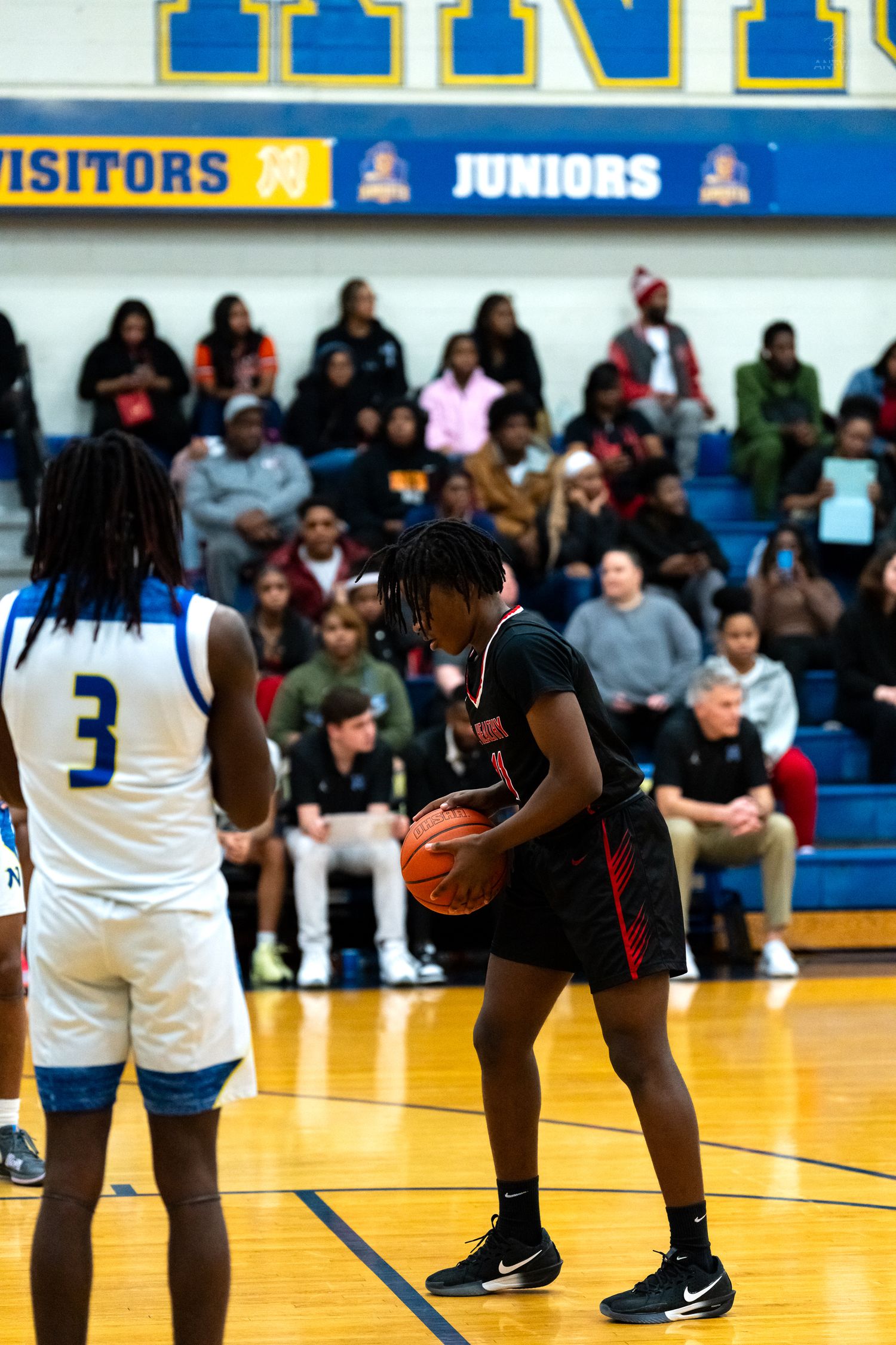 Mt. Healthy player holds basketball at free throw line during game.