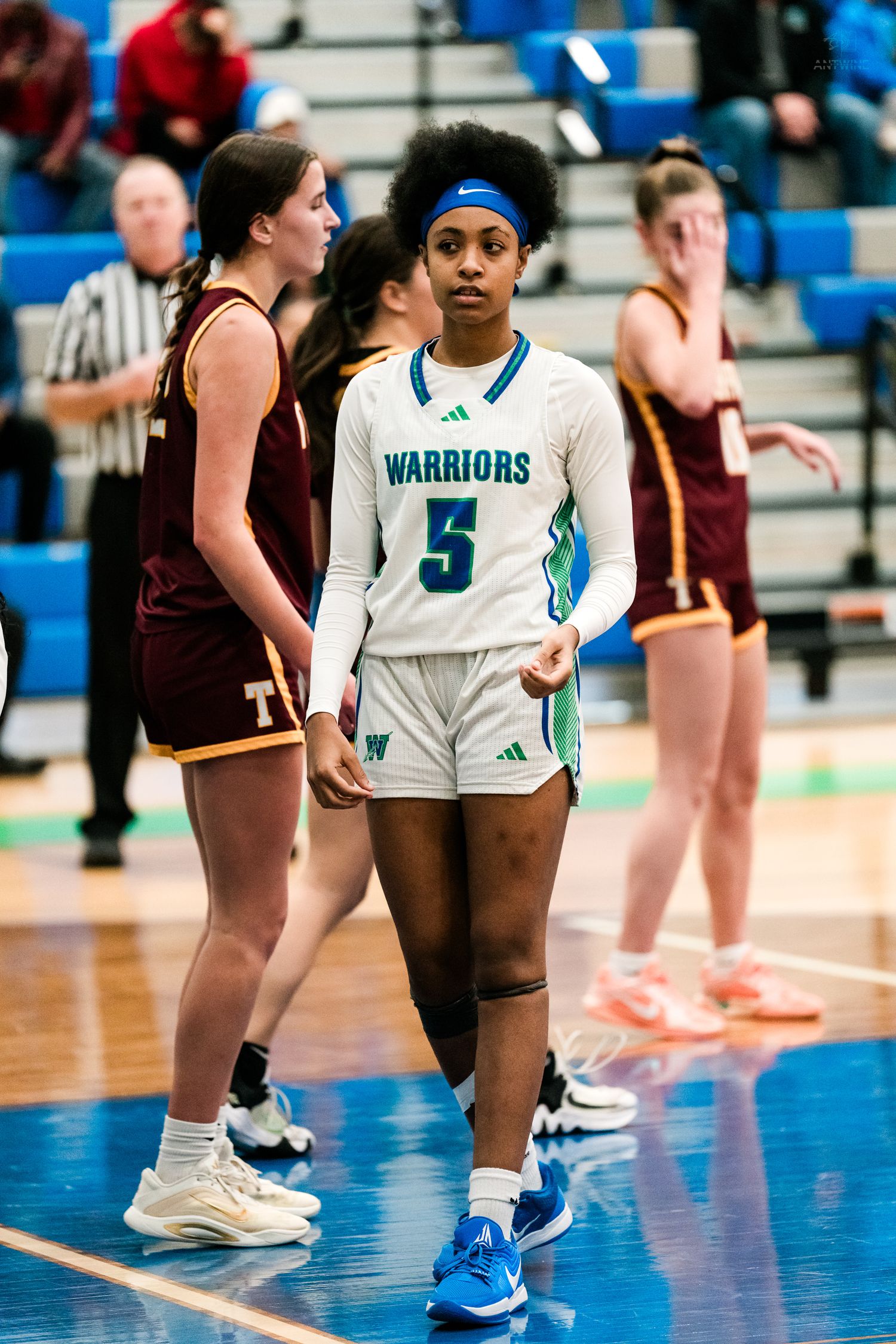 Warriors #5 walks on the court during a girls high school basketball game against Turpin.
