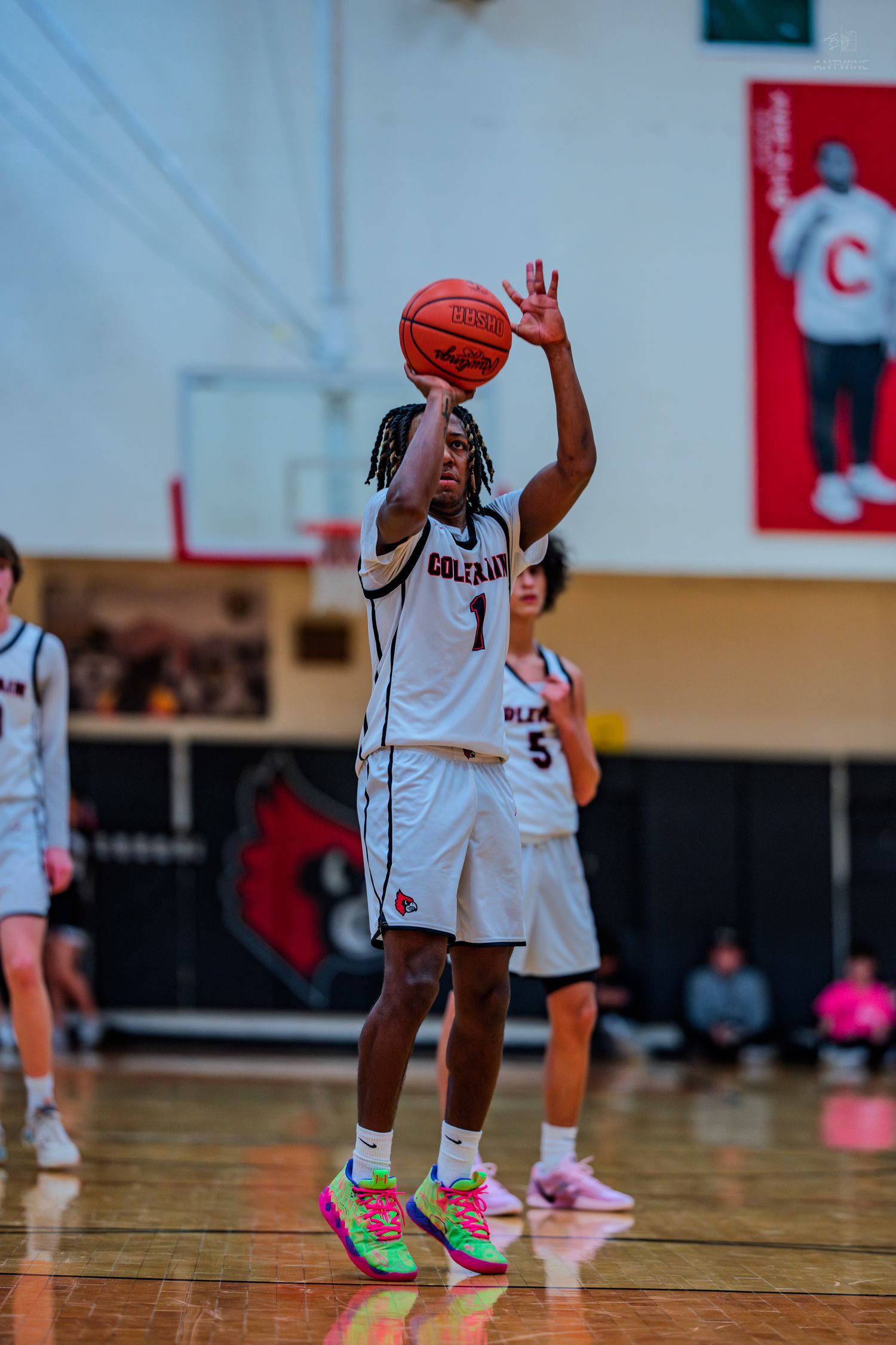 Colerain Cardinals player #1 shoots basketball during high school game wearing bright multicolored sneakers.