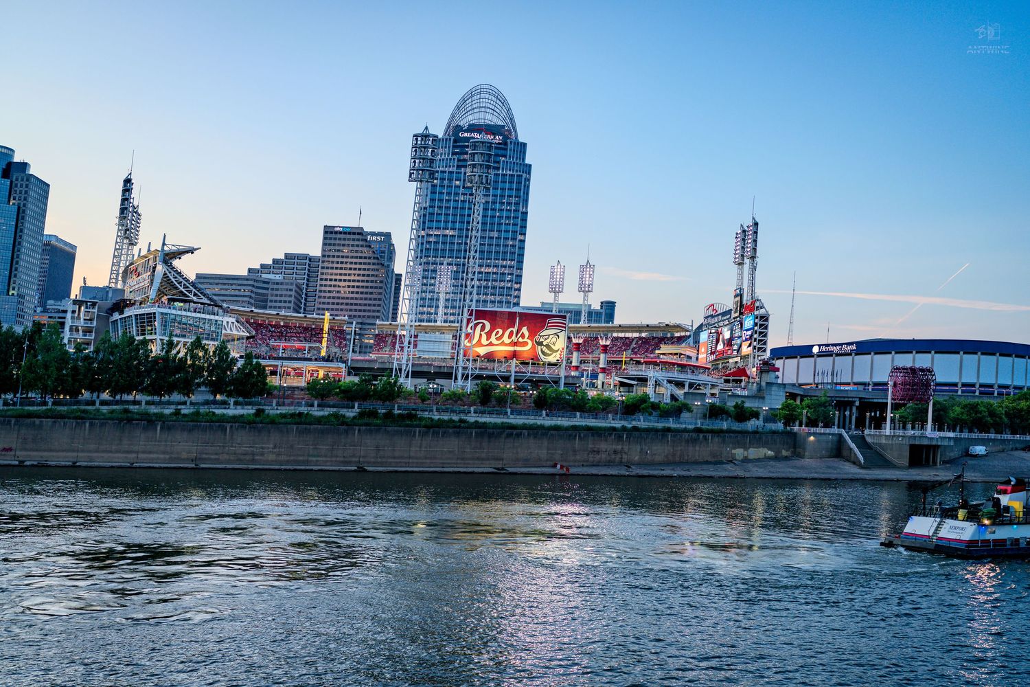 Cincinnati skyline with Great American Ball Park along the Ohio River at dusk.
