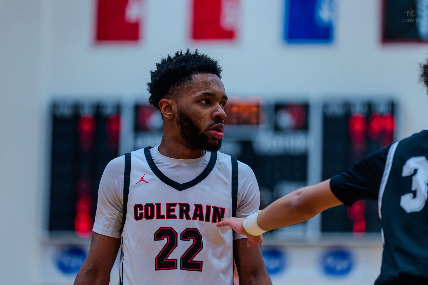 Colerain #22 basketball player receives instruction from referee during high school game.
