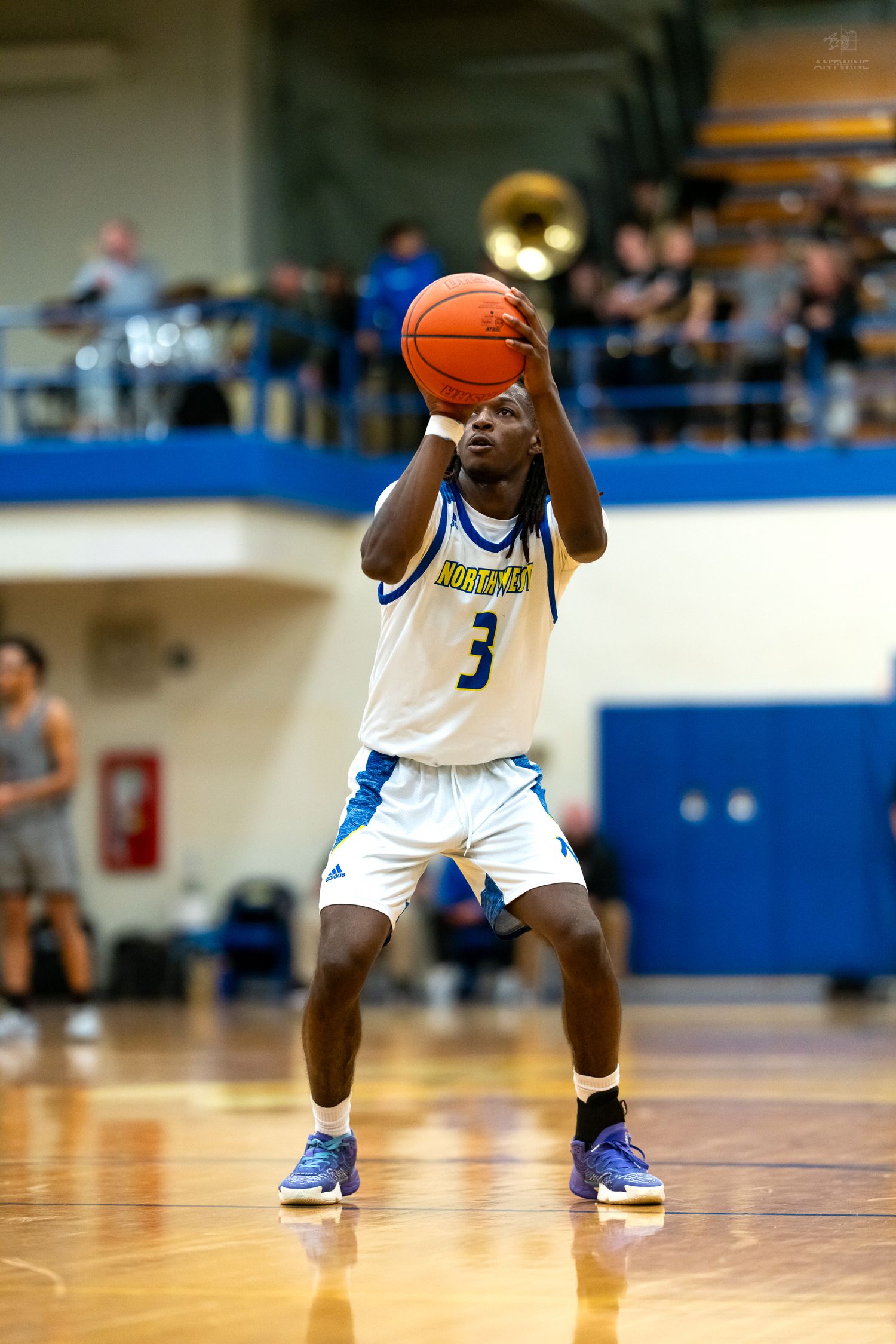 Northwest high school basketball player #3 shoots a free throw during a home game.
