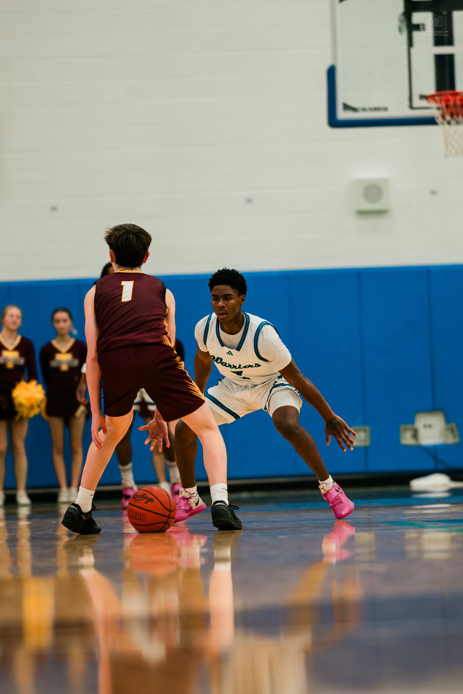 Winton Woods Warriors player defends against Turpin player #1 during a high school basketball game.