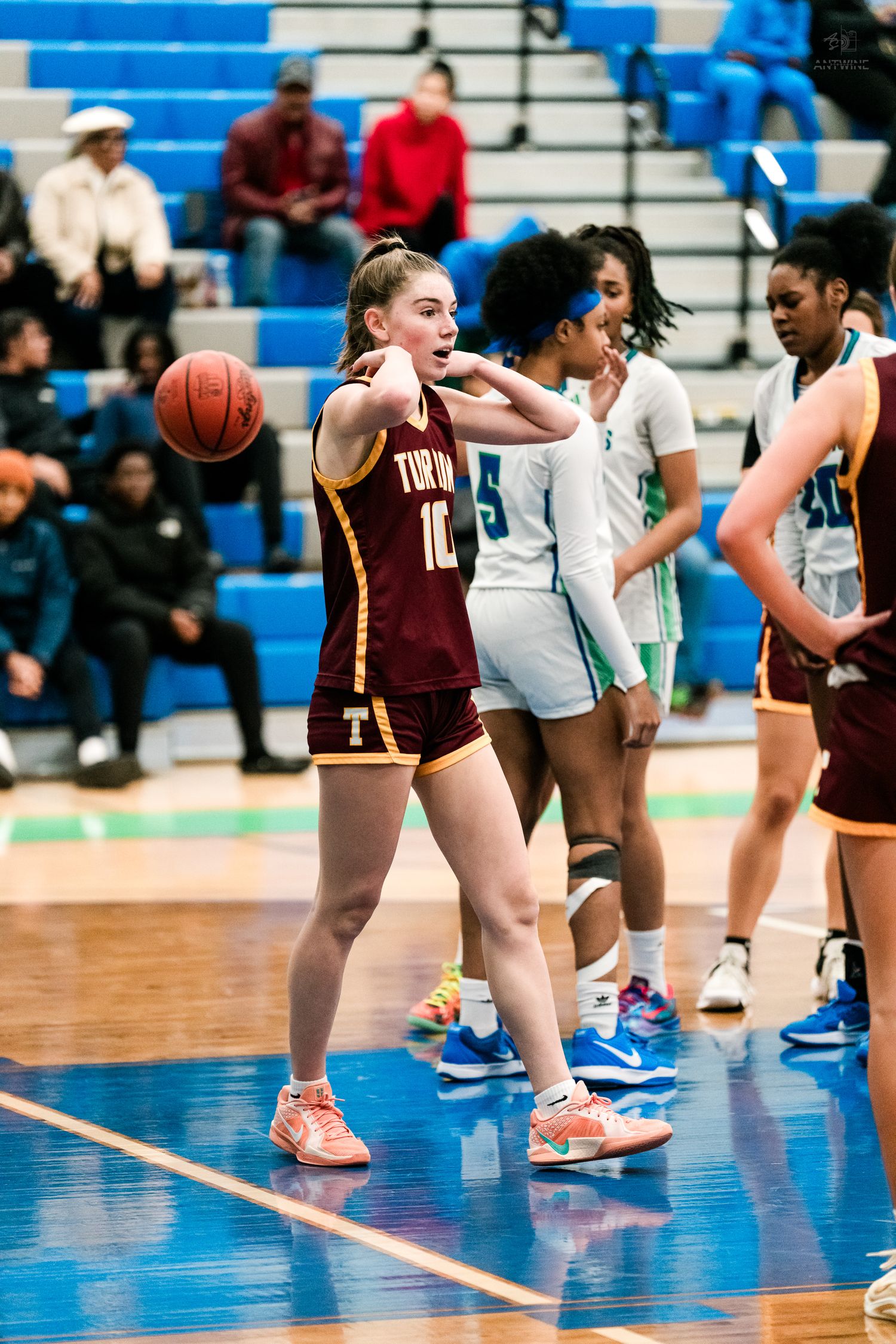 Turpin High School player number 10 gestures on the court during a girls high school basketball game.