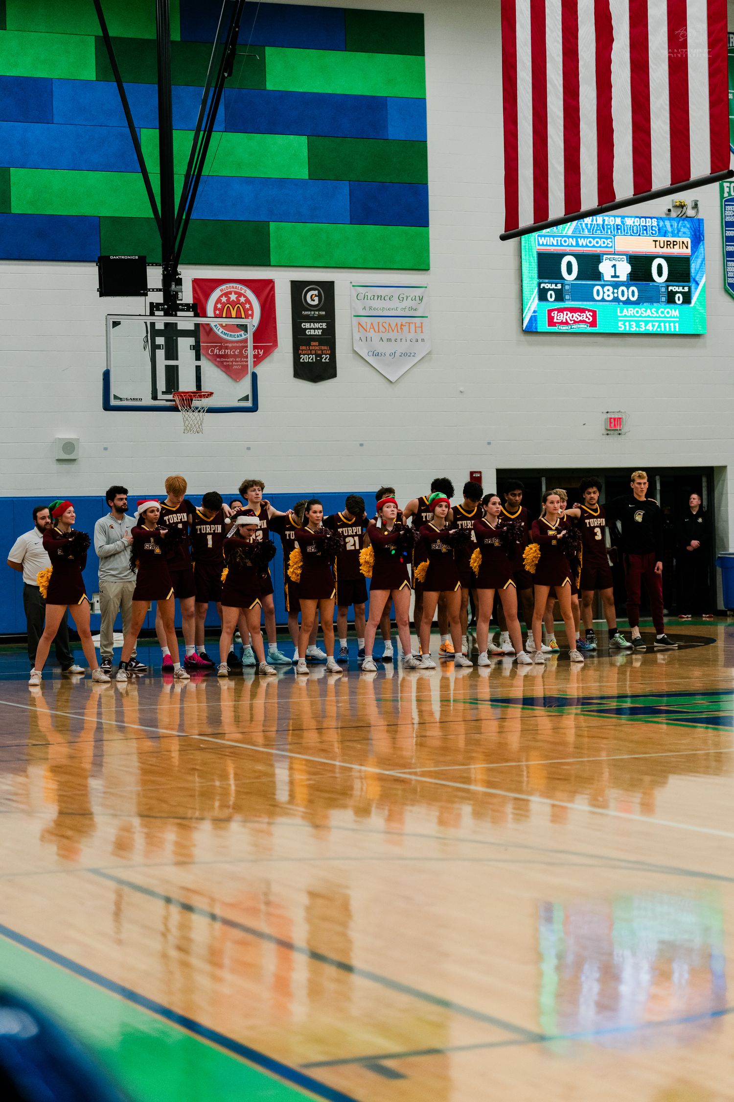 Turpin high school basketball team standing in line on court before tipoff.
