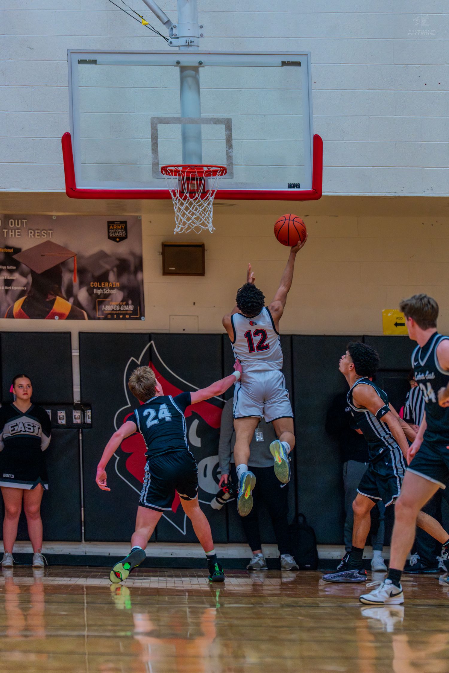 Colerain player number 12 goes up for a layup during a high school basketball game.