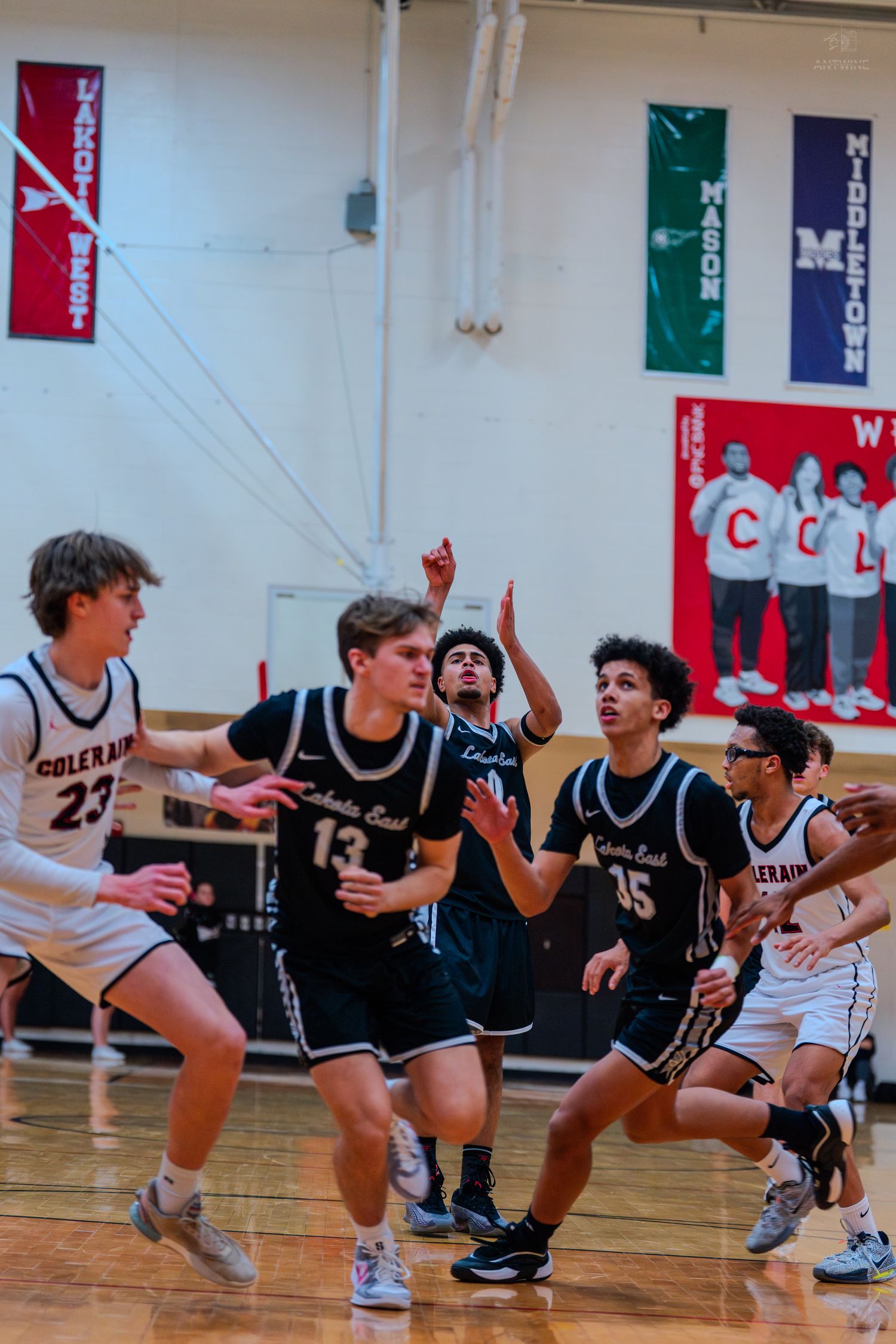 Lakota East and Colerain players battle for rebound in high school game.