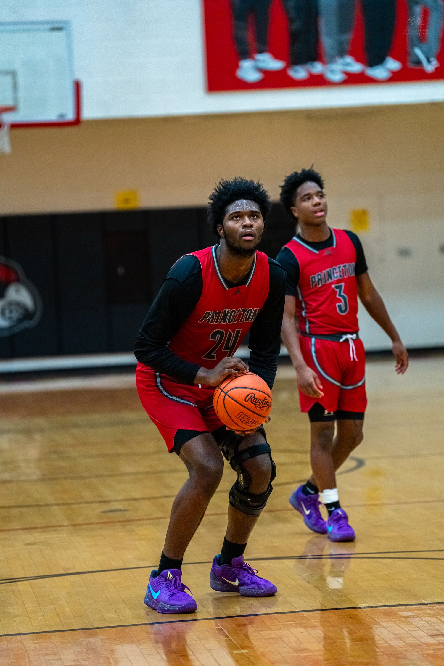 Princeton basketball player number 20 prepares to shoot as teammate number 3 looks on from behind.