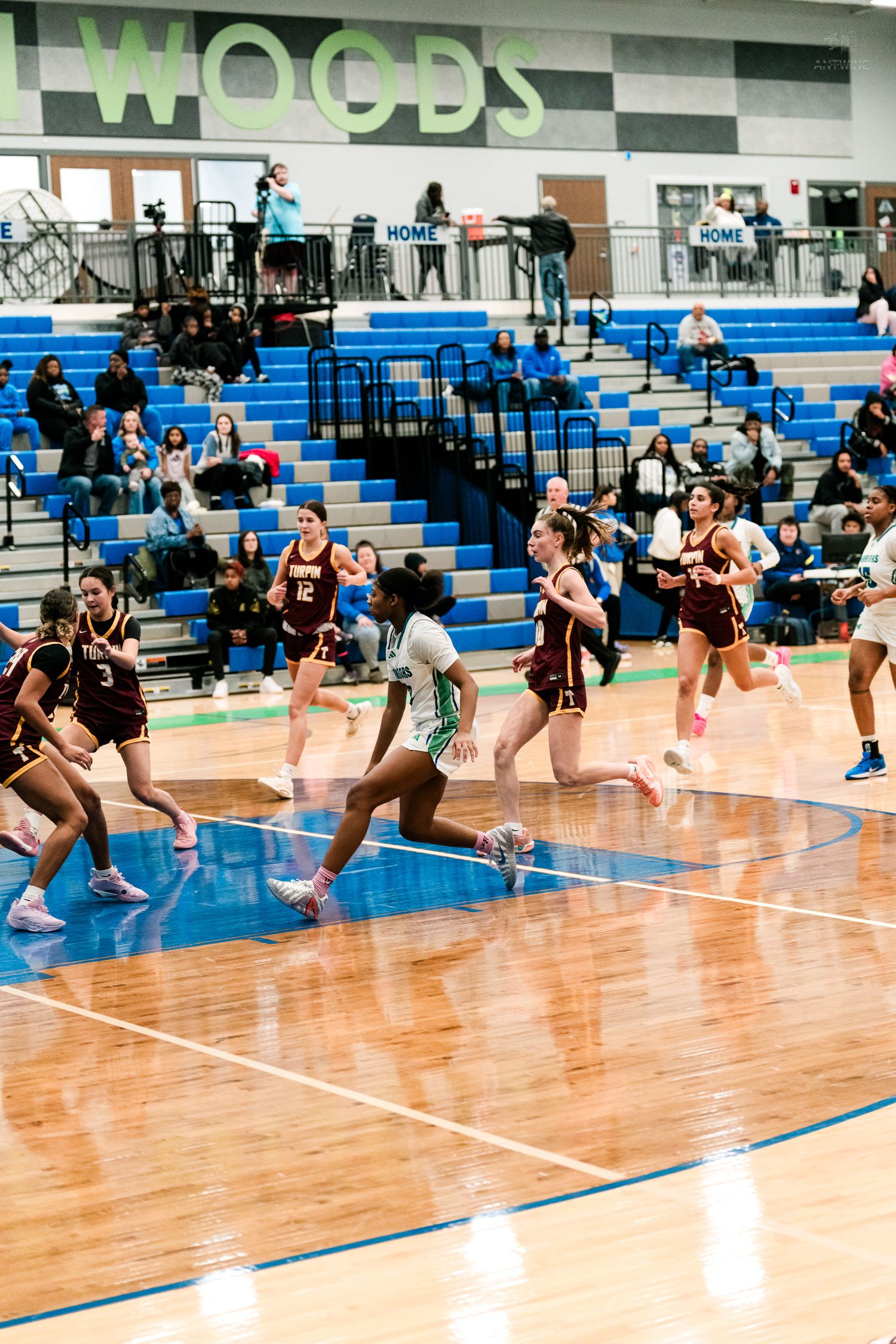 Winton Woods girls basketball players sprint downcourt against Turpin during a fast break.