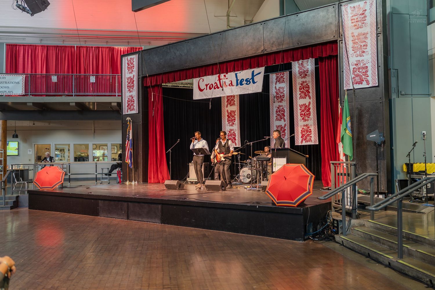Band performing on a decorated stage at ChinaFest cultural event with red curtains and traditional banners.