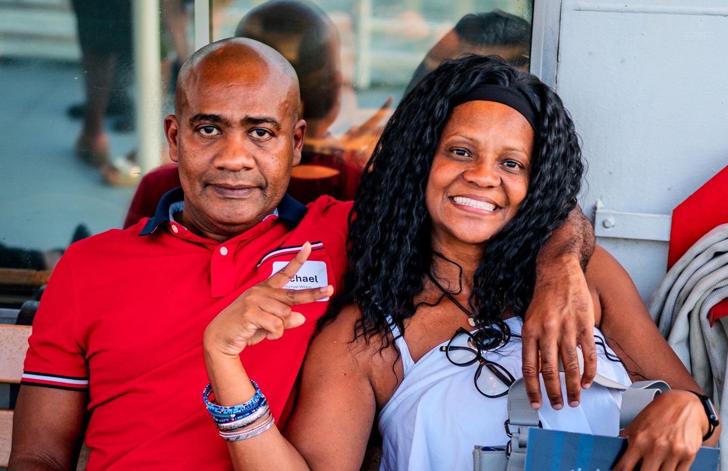 Smiling couple posing closely together on a sunny riverboat cruise event.