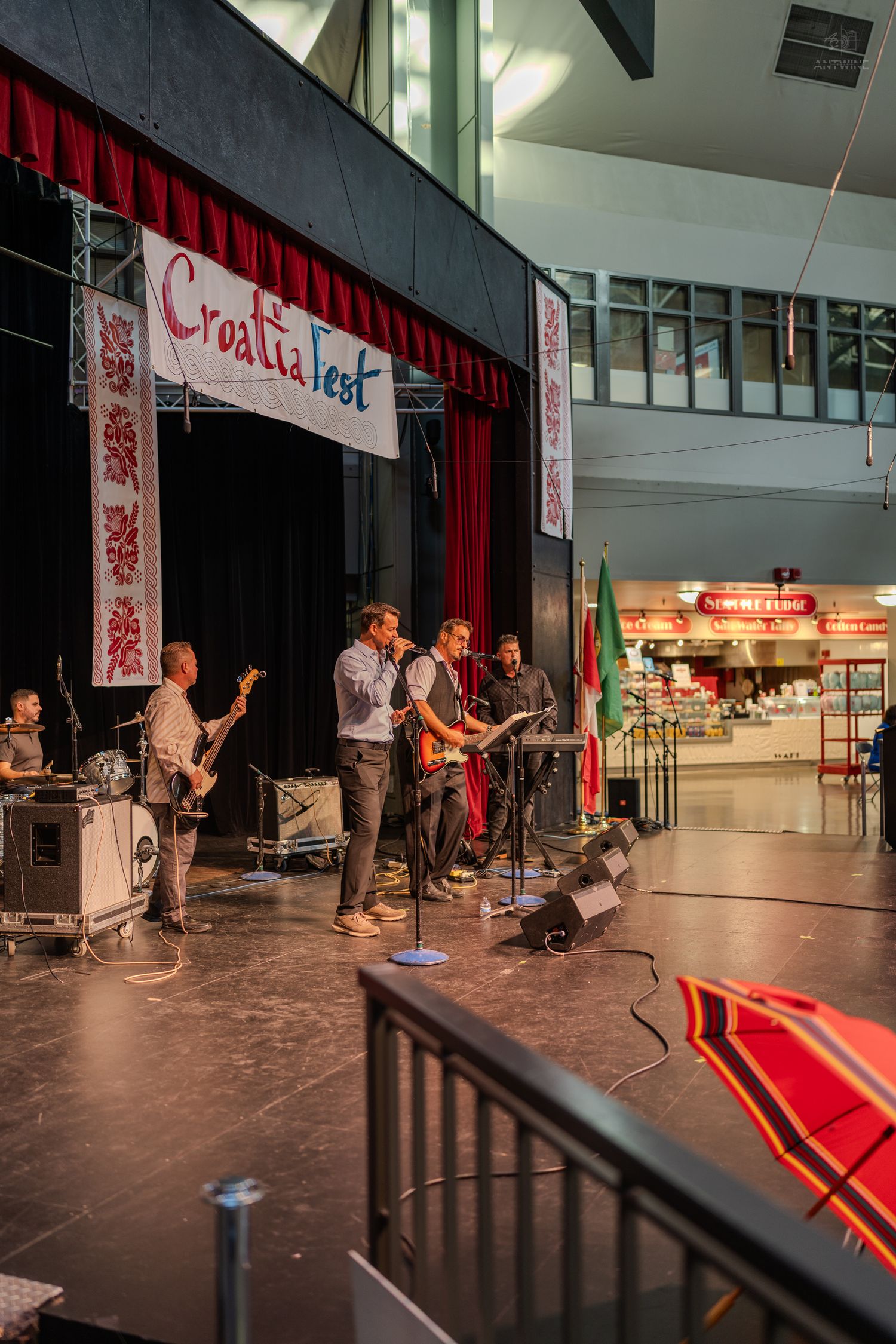 Band performing live on stage at CroatiaFest cultural festival event indoors.
