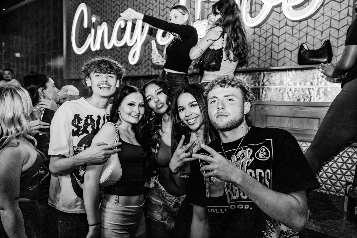 Black and white photo of friends posing at Cincy Love venue nightlife event.