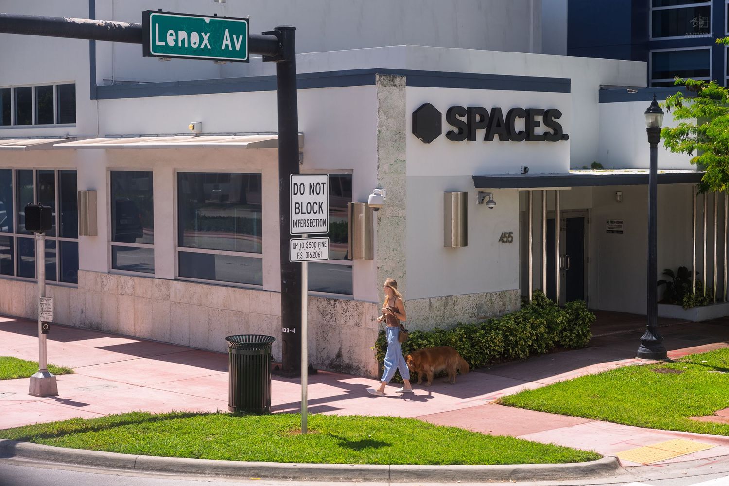 Pedestrian crosses at the corner of Lenox Avenue near a Spaces co-working office in Miami Beach.