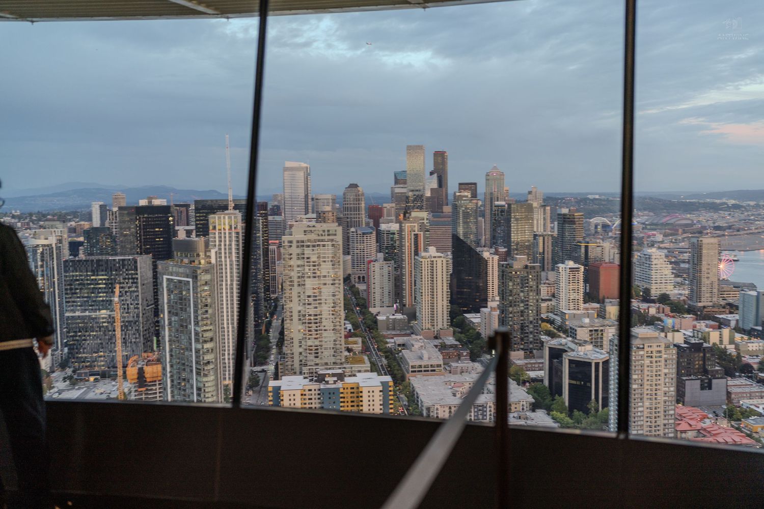 Aerial view of Seattle city skyline with skyscrapers at dusk seen from Space Needle observation deck.