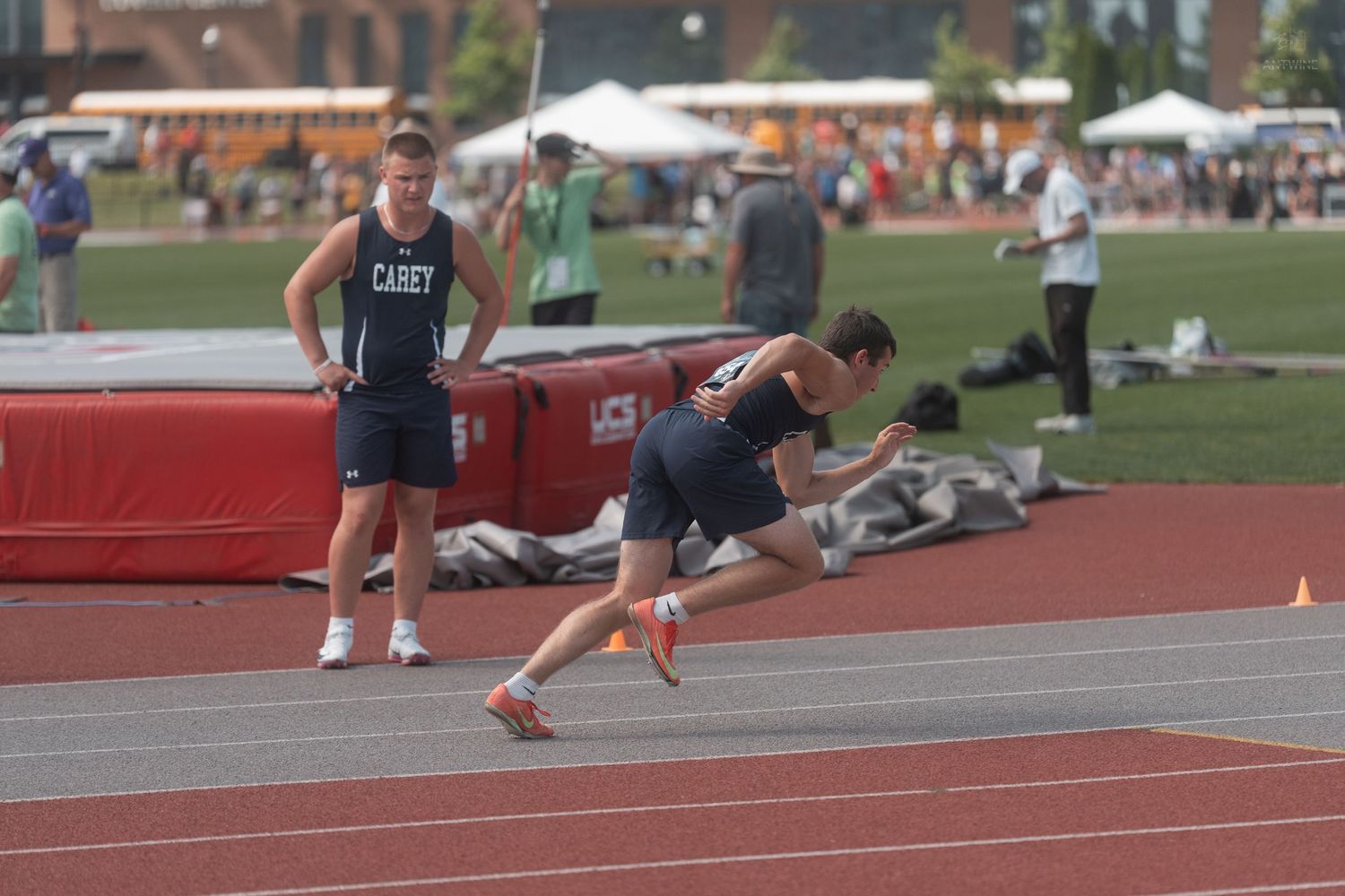 Athlete in Casey uniform sprints off the starting line at an outdoor track and field competition.