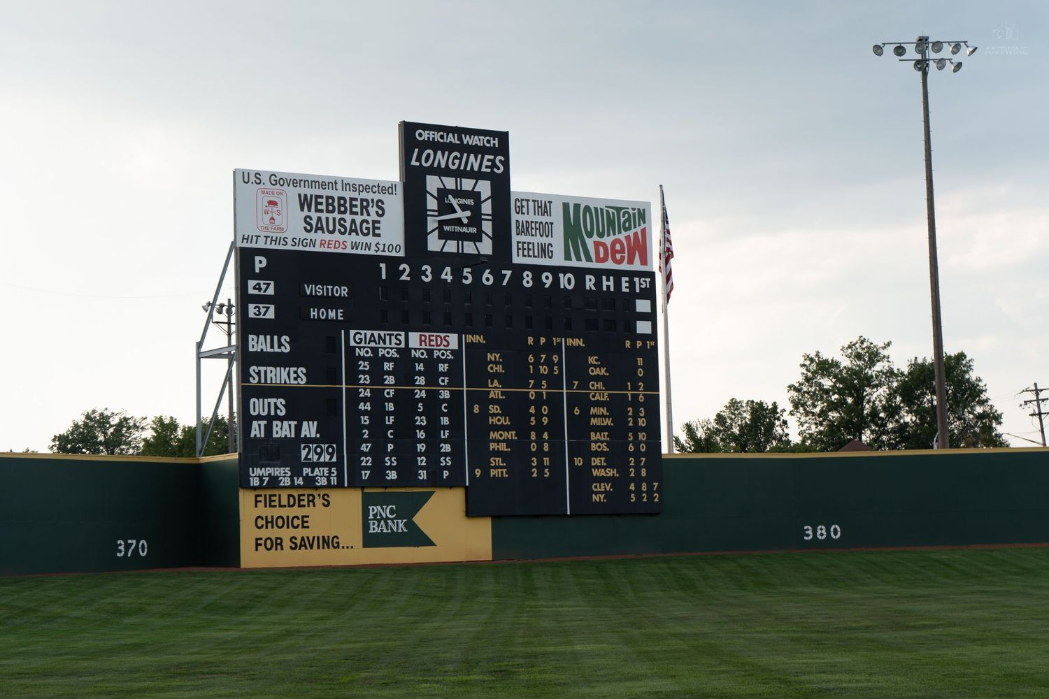 Vintage Longines scoreboard at a baseball stadium featuring Webbers Sausage and Morning Sun ads.