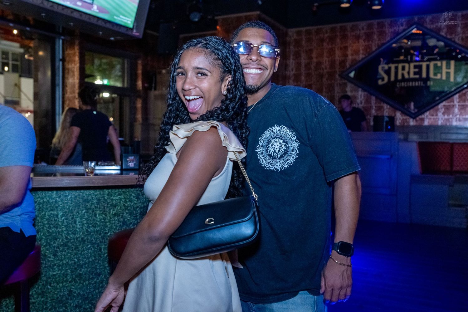 Happy couple laughing and embracing at Stretch Bar venue during a social event.