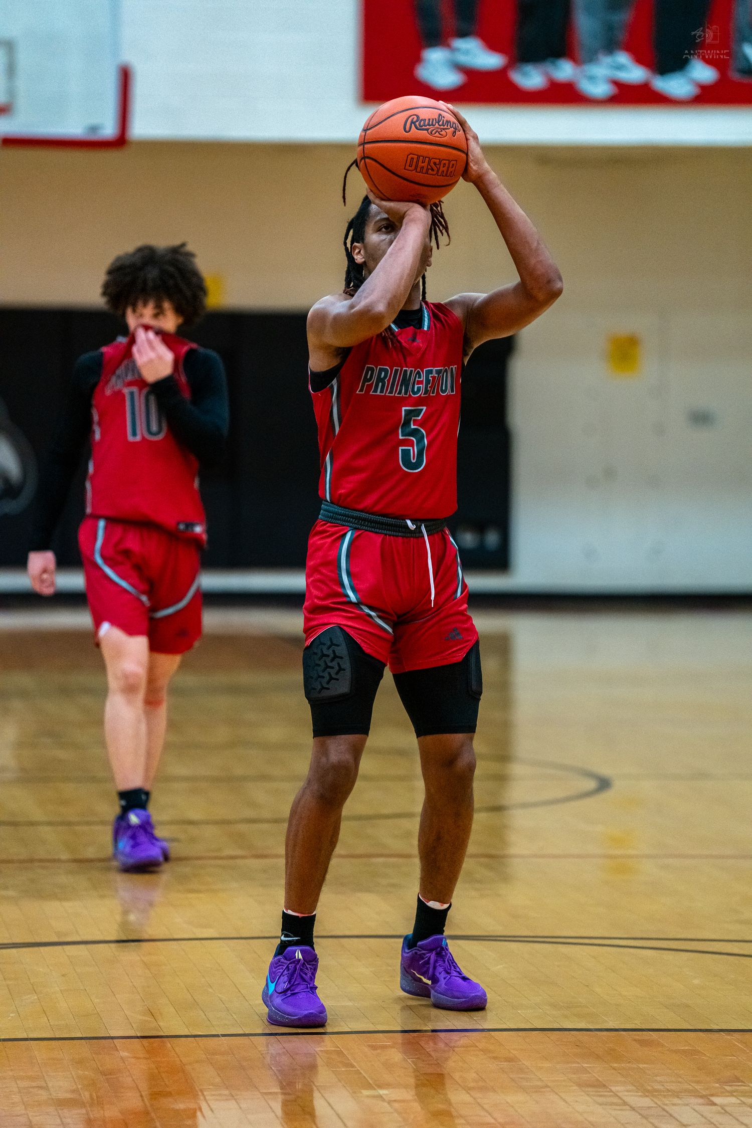 Princeton #5 shoots free throw during high school basketball game with teammate #10 visible in background.