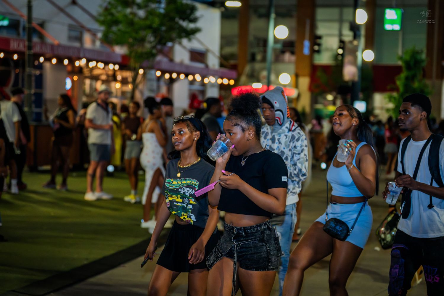 People enjoying a lively outdoor nighttime street festival event.