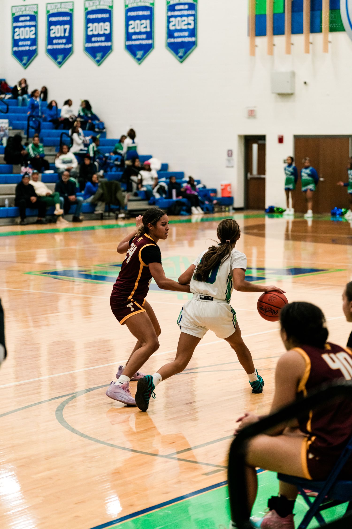 Turpin player defends Warriors dribbler near sideline during girls high school basketball game.