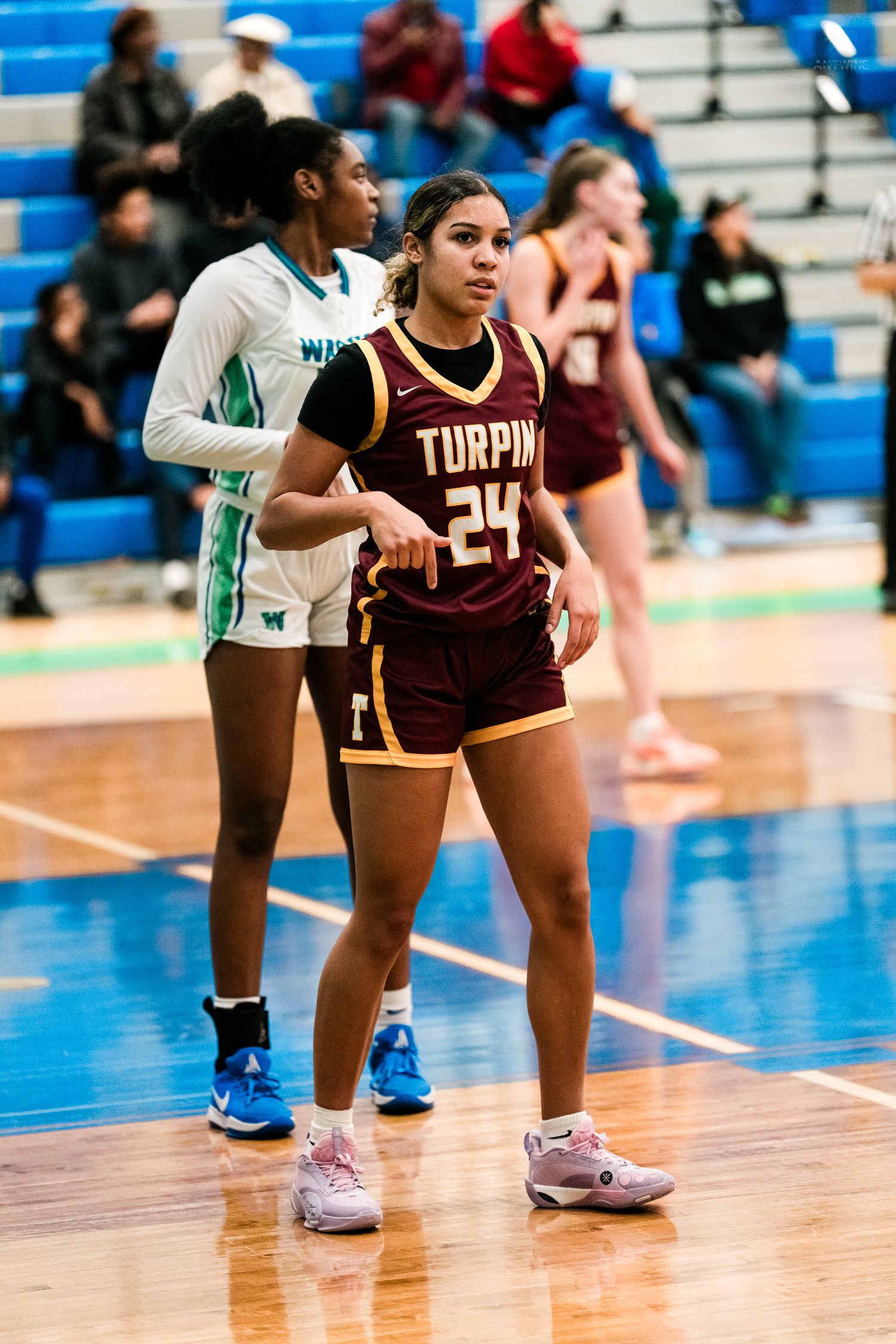 Turpin girls basketball player #24 positions for a rebound during a game against the Warriors.