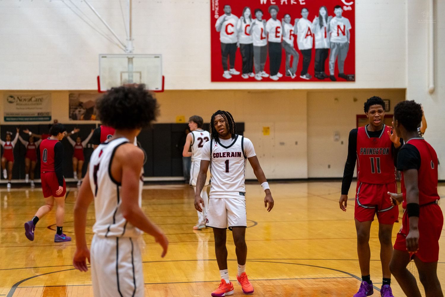 Colerain player number 1 walks on the court beneath the We Are Colerain banner during a game.
