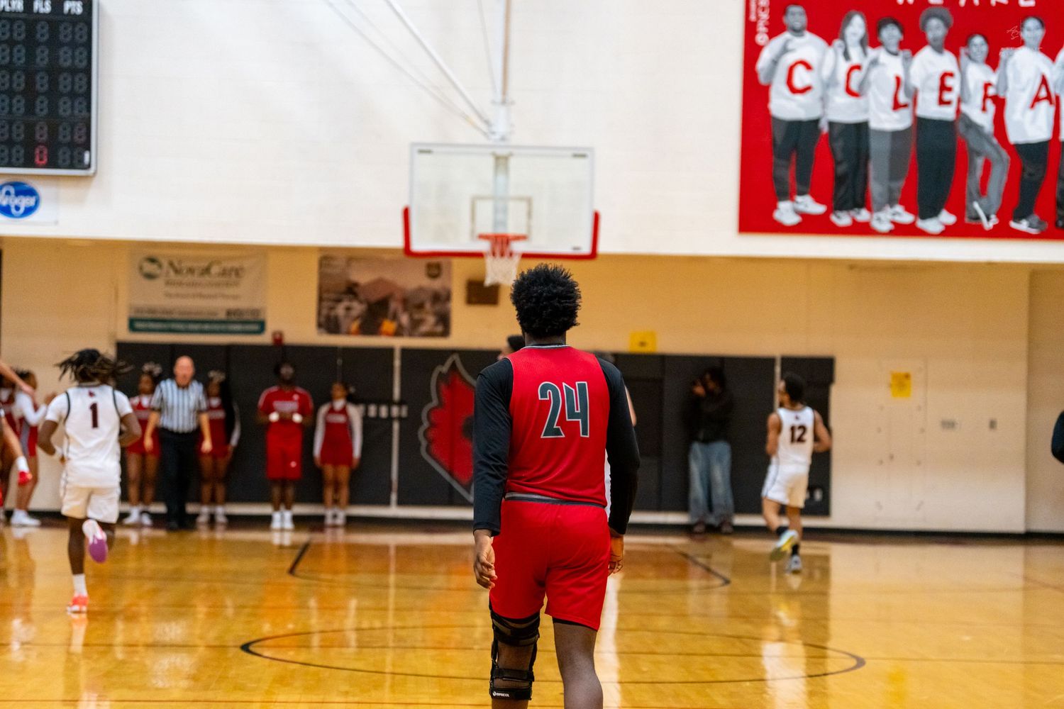Player number 24 in red stands on the basketball court during a high school game at Colerain.