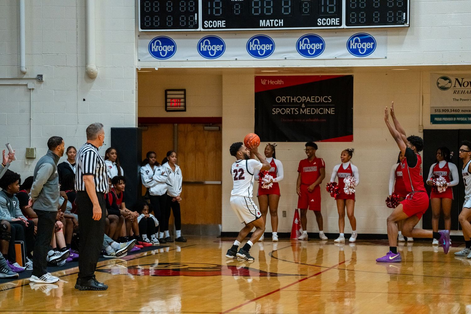 Female basketball player #22 shoots during a high school girls basketball game.