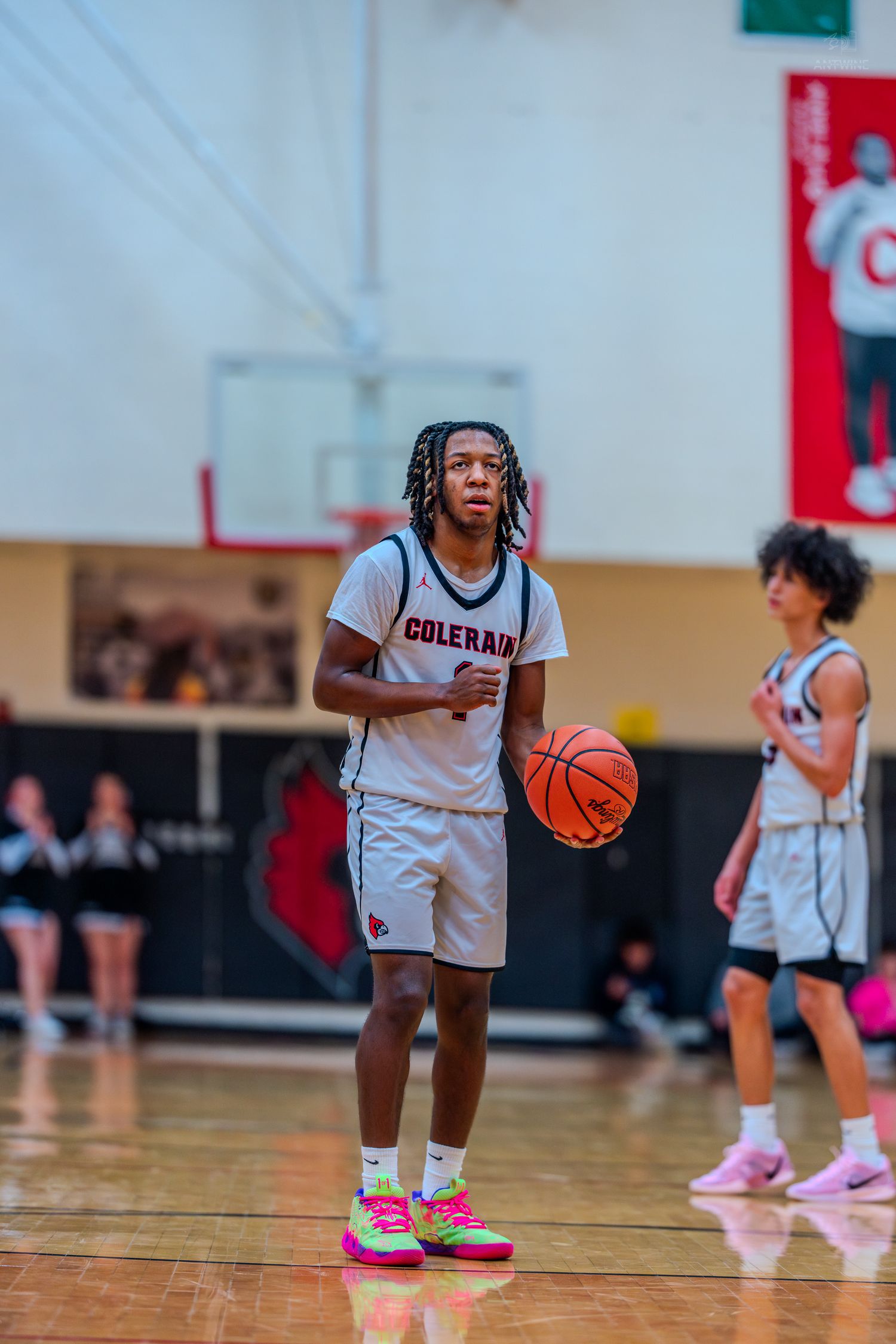 Colerain Cardinals #1 holds basketball at free throw line during high school basketball game in home gymnasium.