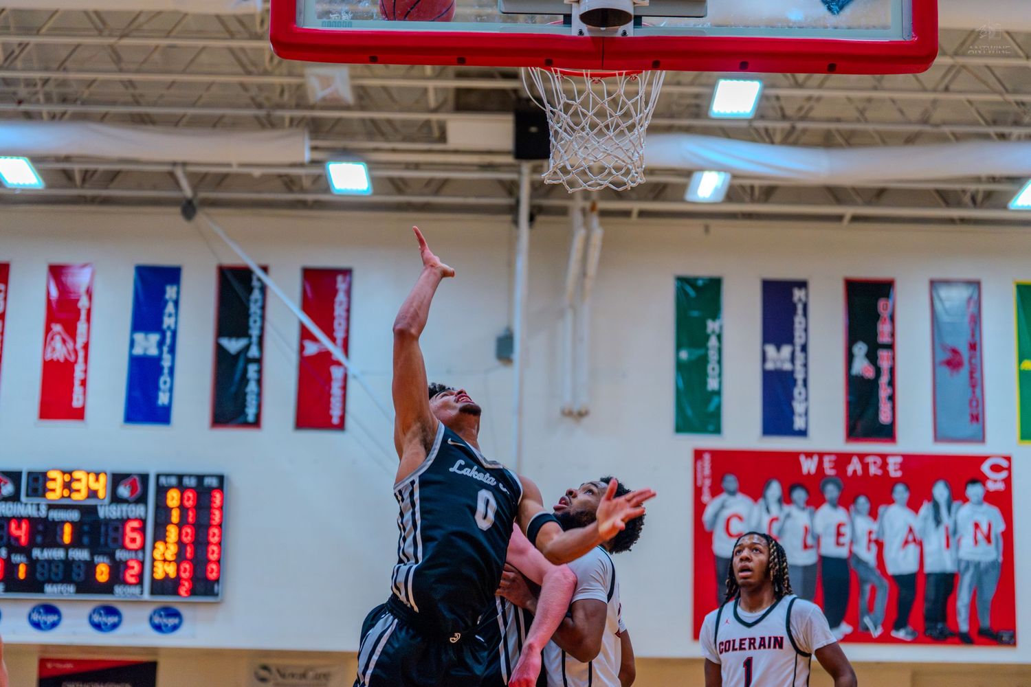 Lakota East #0 goes up for a layup during a high school basketball game.