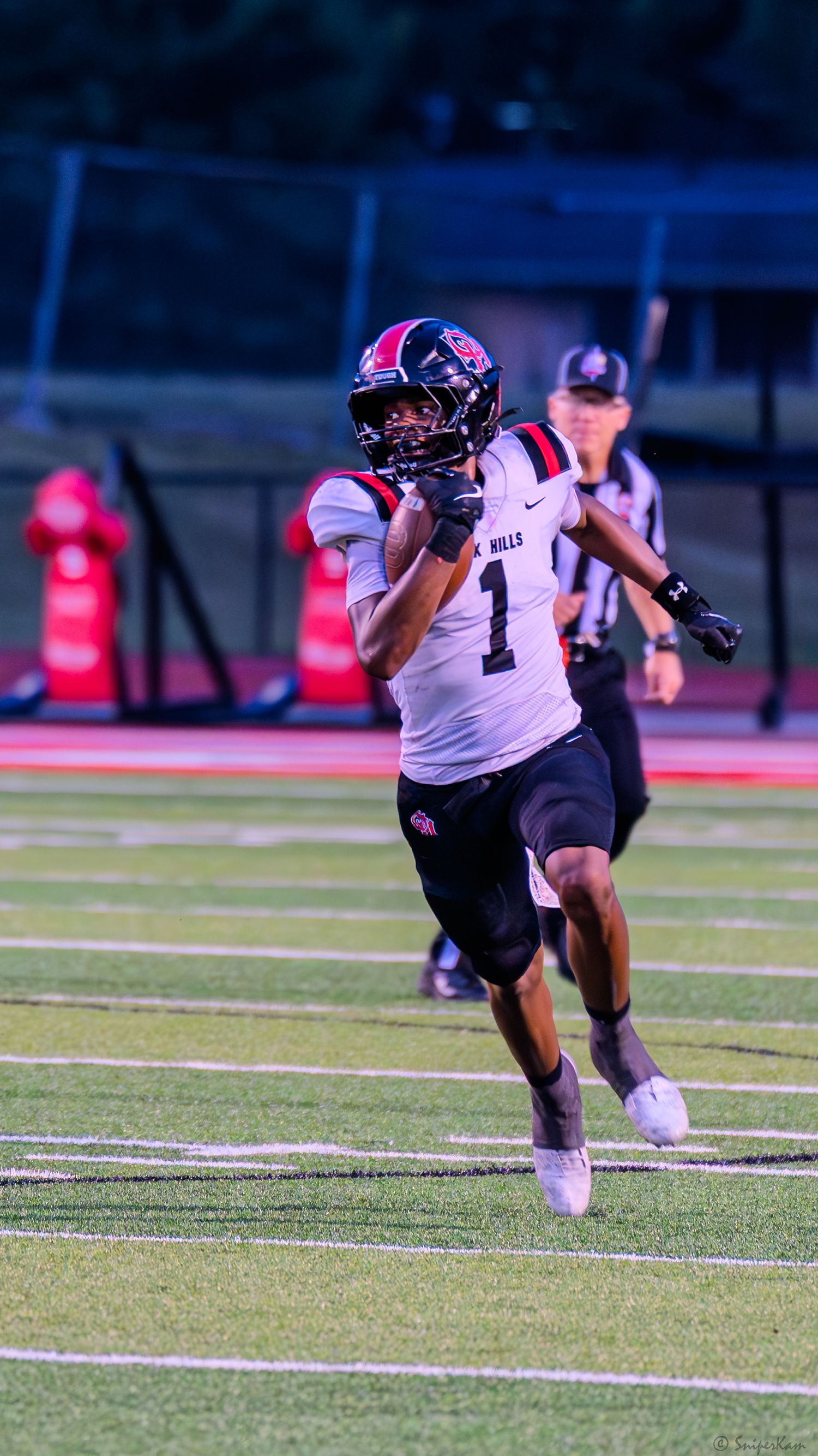 Football player number 1 in white Oak Hills uniform catches a pass during a game.