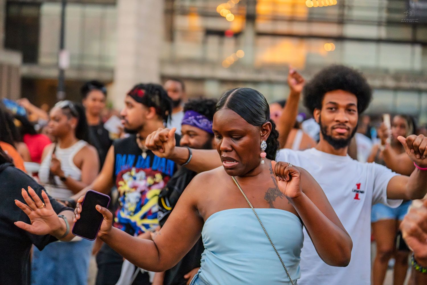 People dancing joyfully outdoors at a vibrant community street celebration event.
