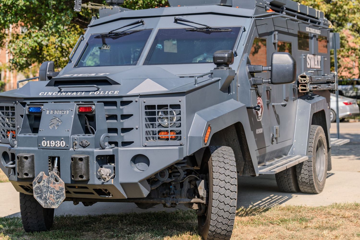 Cincinnati Police SWAT armored tactical vehicle parked outdoors, gray military-style truck with heavy-duty equipment.