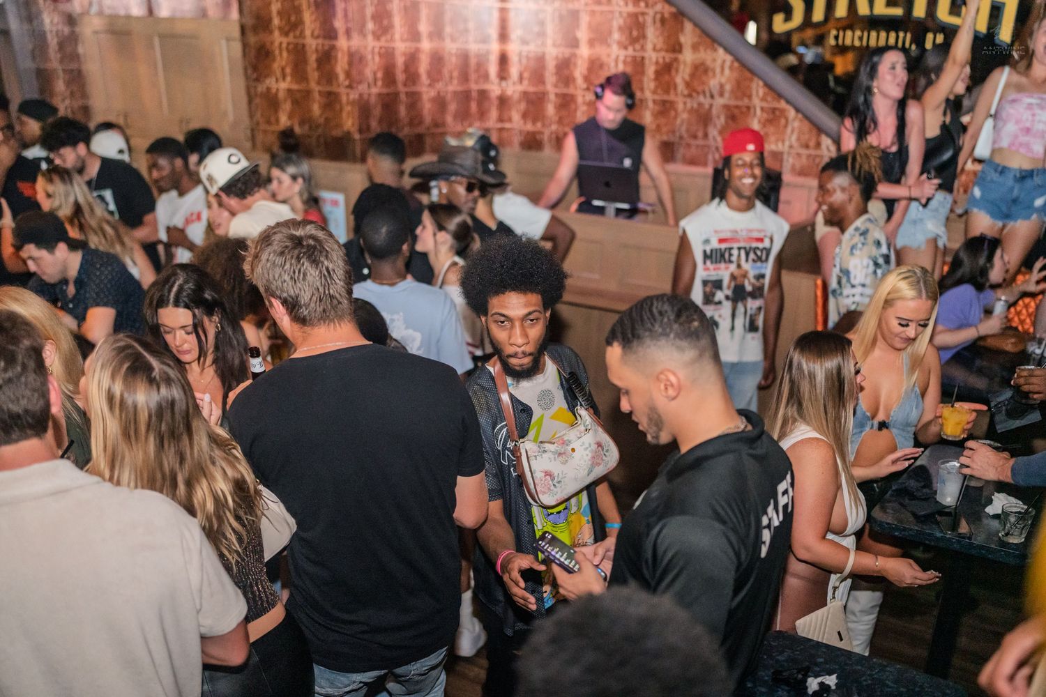 Diverse crowd socializing at Stretch Cincinnati bar event with lively atmosphere.