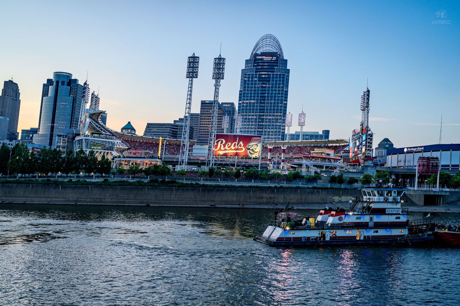 Cincinnati skyline at dusk with Great American Ball Park and the Ohio River in the foreground.