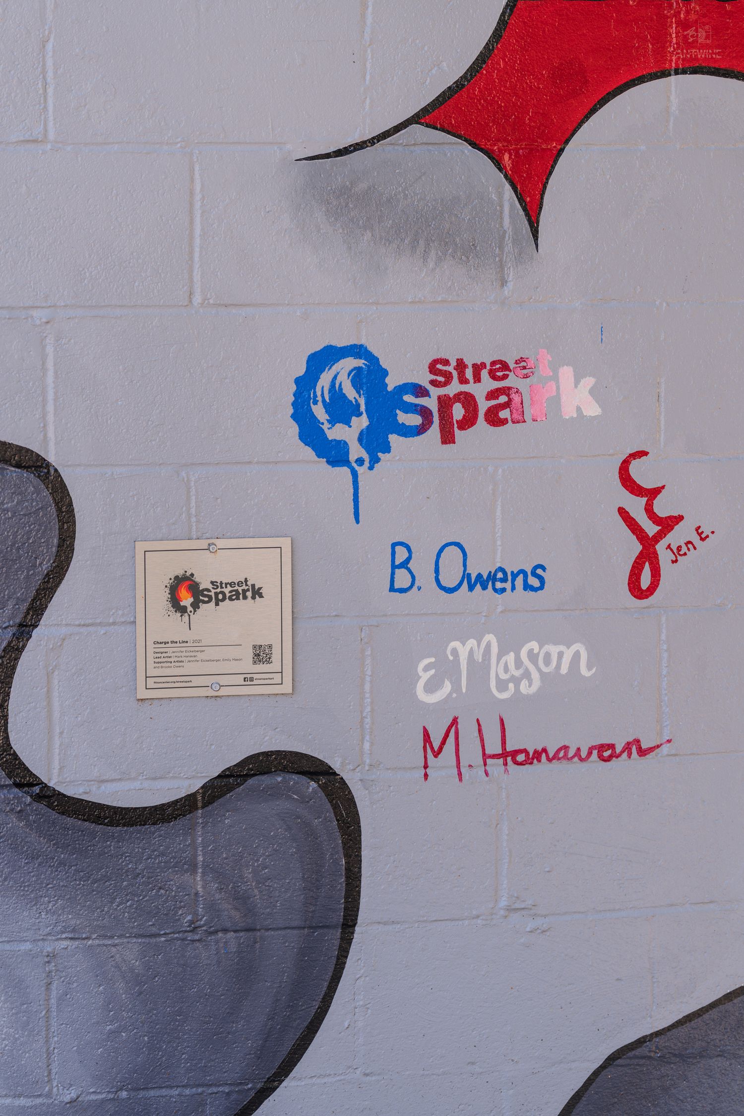 Street Spark mural on brick wall signed by artists B. Owens, E. Mason, M. Hanavan, and Jen E.